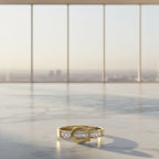 SVORA Lumiere Belt Eternity Ring in gold tone stainless steel with channel-set baguette cubic zirconia stones, inspired by a belt buckle.