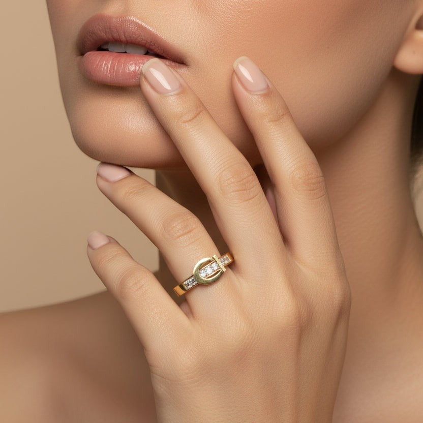 SVORA Lumiere Belt Eternity Ring in gold tone, featuring a buckle design with channel-set cubic zirconia stones.