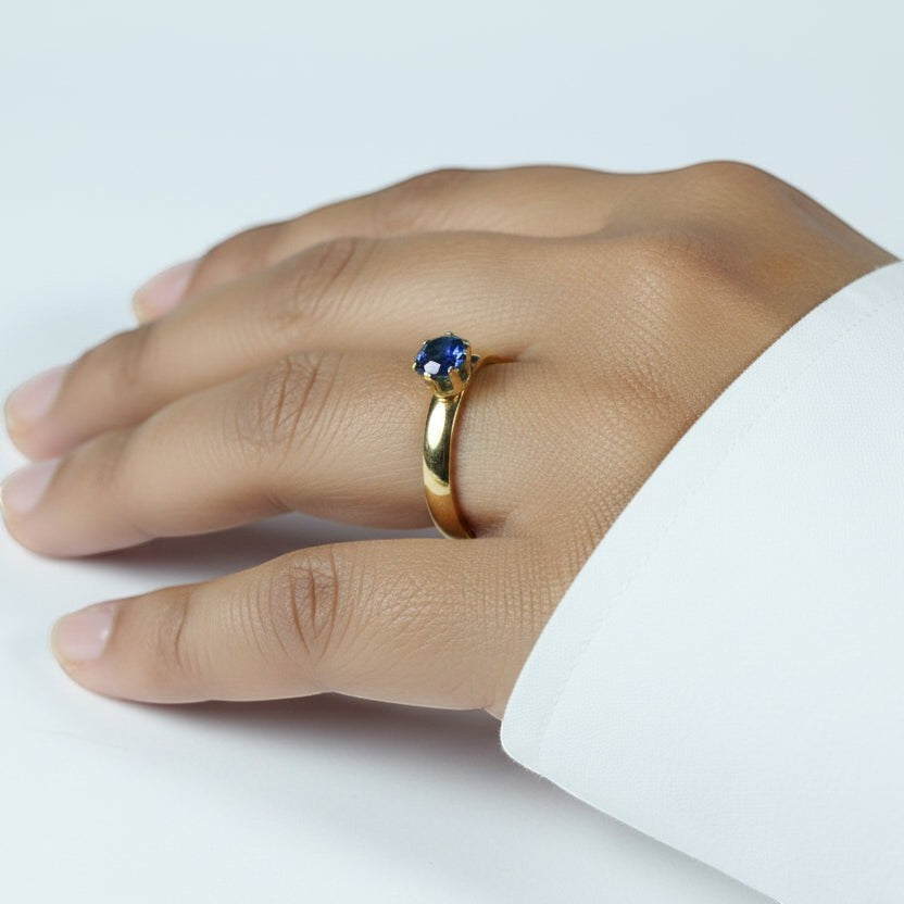 SVORA Lumiere Blue Solitaire Ring with a sapphire blue cubic zirconia set in 18K gold plated stainless steel.
