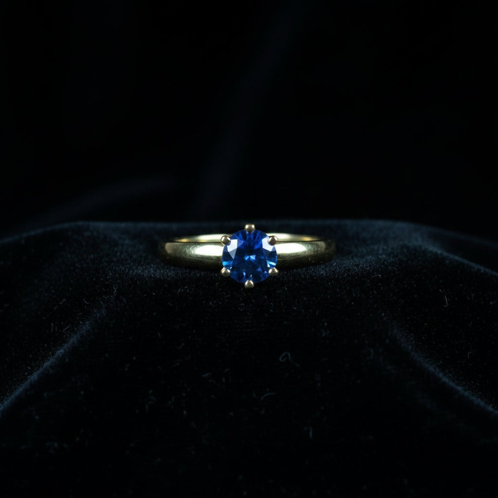 SVORA Lumiere Blue Solitaire Ring with a sapphire blue cubic zirconia set in 18K gold plated stainless steel.