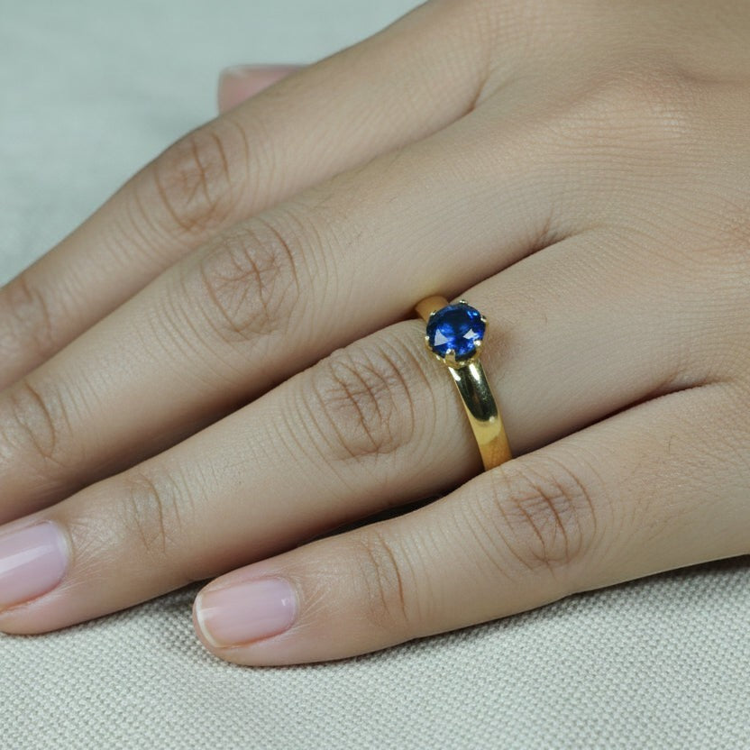 SVORA Lumiere Blue Solitaire Ring with a sapphire blue cubic zirconia set in 18K gold plated stainless steel.