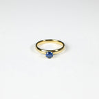 SVORA Lumiere Blue Solitaire Ring with a sapphire blue cubic zirconia set in 18K gold plated stainless steel.