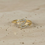 SVORA gold plated stainless steel Lumiere Chevron Slim Ring with small stones along a zigzag line.