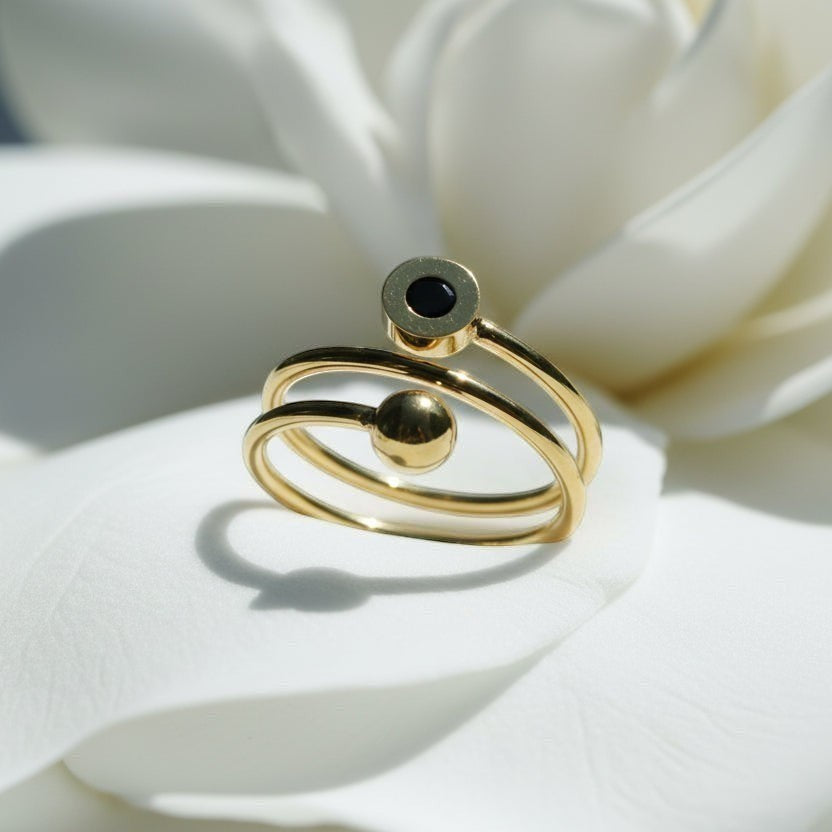 SVORA Lumiere Eclipse Spiral Ring in gold tone stainless steel with a black accent.