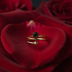 SVORA Lumiere Eclipse Spiral Ring in gold tone 18K plated stainless steel with a black stone accent and a ball detail.