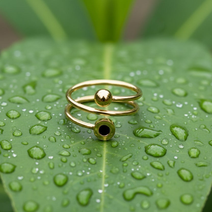 SVORA Lumiere Eclipse Spiral Ring in gold-tone stainless steel with a polished finish and a black accent.