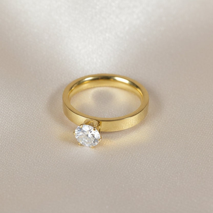 SVORA Lumiere Princess Solitaire Ring in gold, featuring a princess-cut cubic zirconia on a brushed gold band. Bezel-set for a secure and modern look.