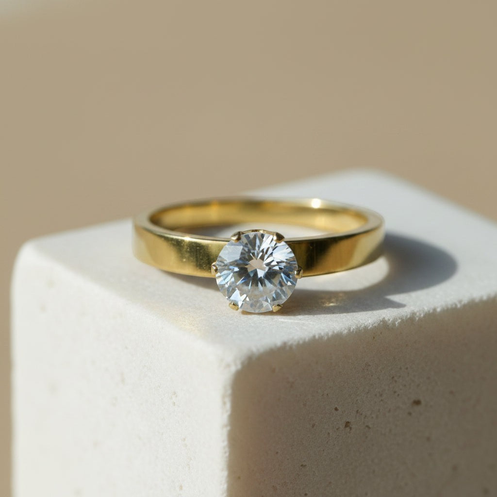 SVORA Lumiere Princess Solitaire Ring in gold-plated stainless steel with a large, clear princess-cut stone.