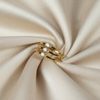 SVORA Lumiere Trilogy Spiral Ring in gold tone stainless steel with three cubic zirconia stones, elegant and modern design.
