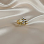 SVORA Lumiere Trilogy Spiral Ring in gold-tone stainless steel with three clear cubic zirconia stones.