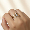 SVORA Lumiere Trilogy Spiral Ring in gold tone stainless steel with three cubic zirconia stones. A sculptural wrap ring.
