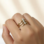 SVORA Lumiere Trilogy Spiral Ring in gold tone stainless steel with three cubic zirconia stones. A sculptural wrap ring.