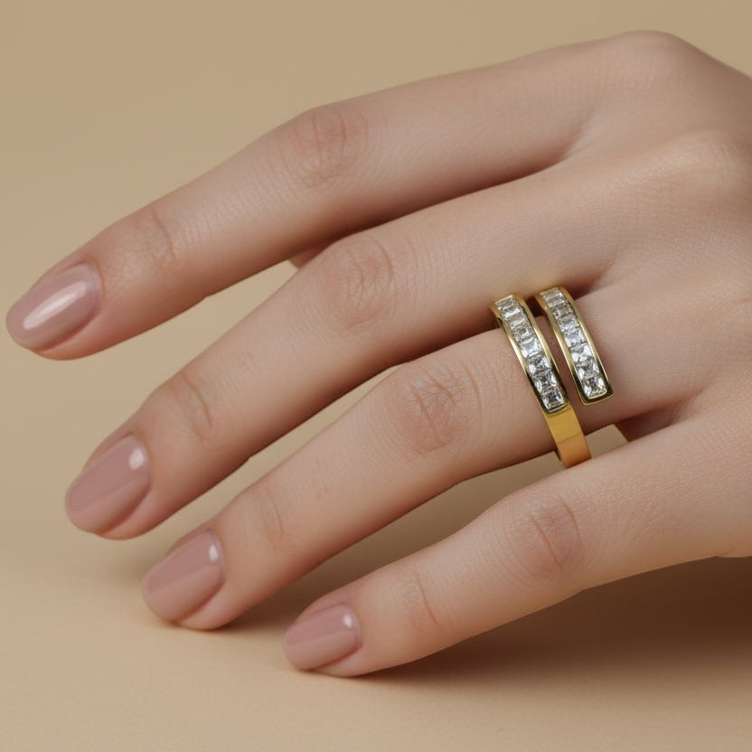 SVORA Lumiere Twin Spark Ring in gold tone, featuring a spiral design with channel-set cubic zirconia stones. Made from 316L stainless steel with 18K gold plating.