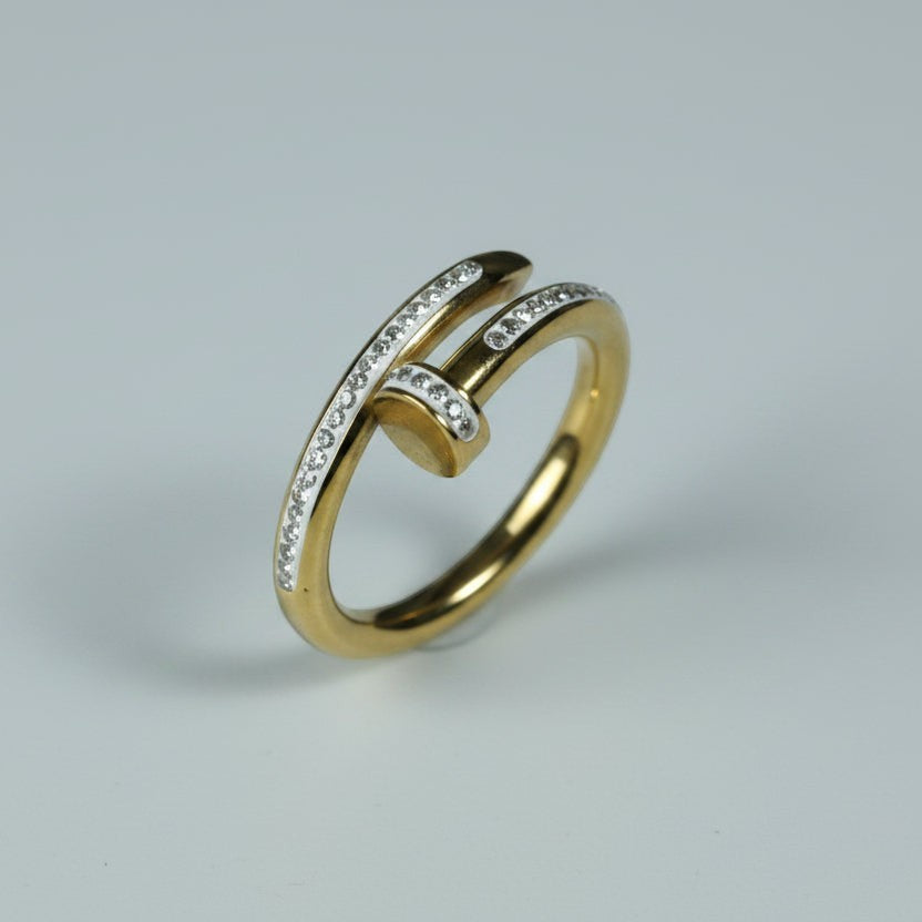 SVORA gold stainless steel Lumiere Twist Wrap Ring with pavé-set crystals, featuring a unique nail-head design.