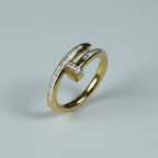SVORA gold stainless steel Lumiere Twist Wrap Ring with pavé-set crystals, featuring a unique nail-head design.
