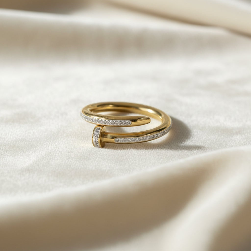 SVORA gold plated stainless steel Lumiere Twist Wrap Ring with pavé-set diamonds and a nail head design.