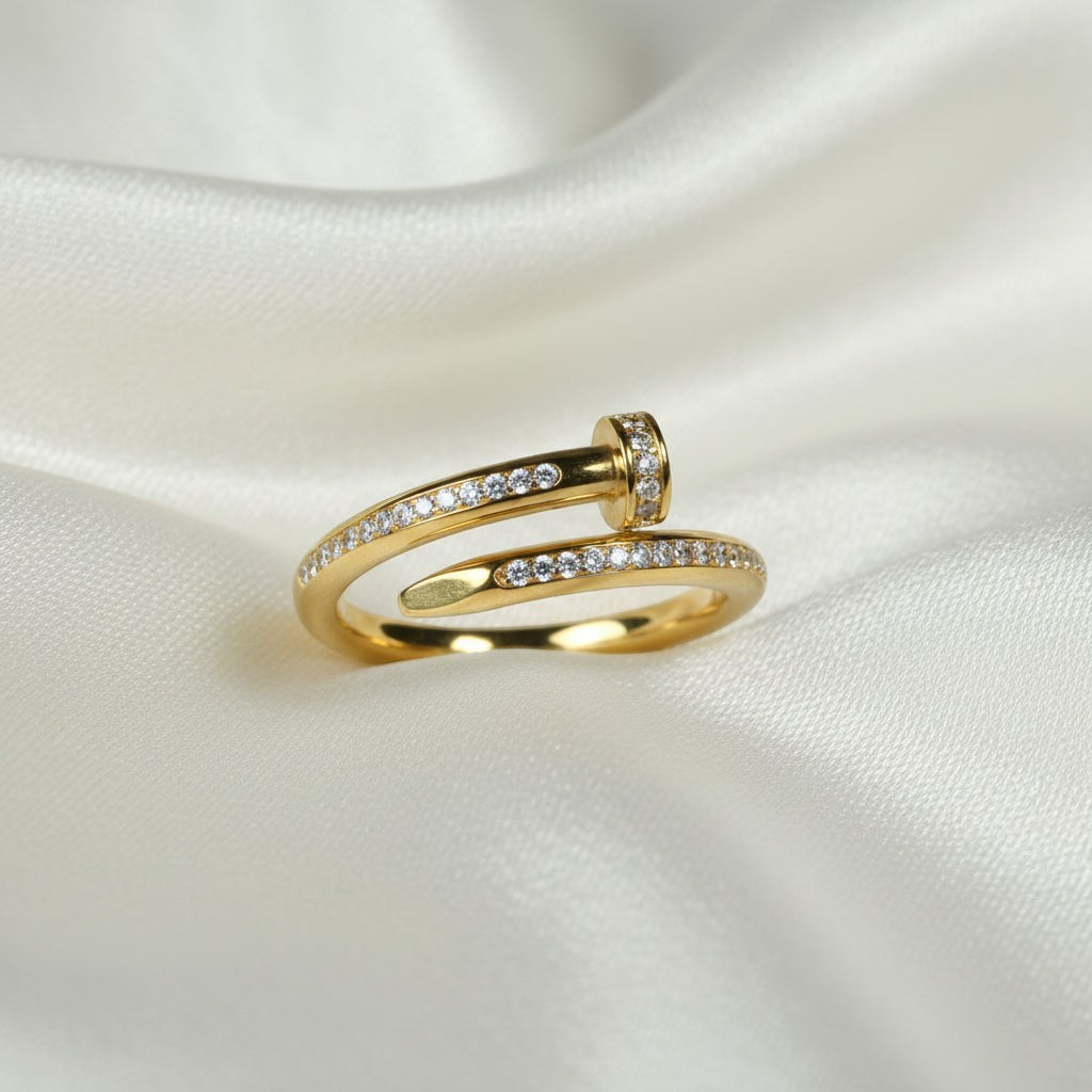 SVORA Lumiere Twist Wrap Ring in gold, featuring a pavé-set band twisting around the finger with a rounded head and tapered point.
