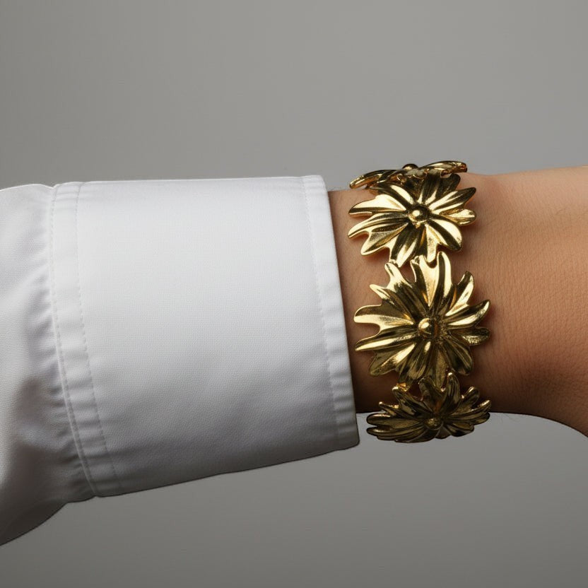 SVORA gold-plated stainless steel Marigold Bloom cuff bracelet with five oversized flower charms.
