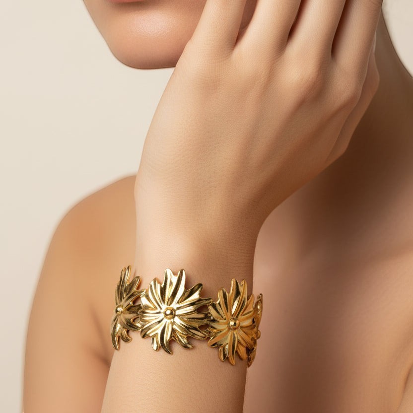 SVORA gold plated stainless steel Marigold Bloom cuff bracelet with five oversized floral details, adjustable.
