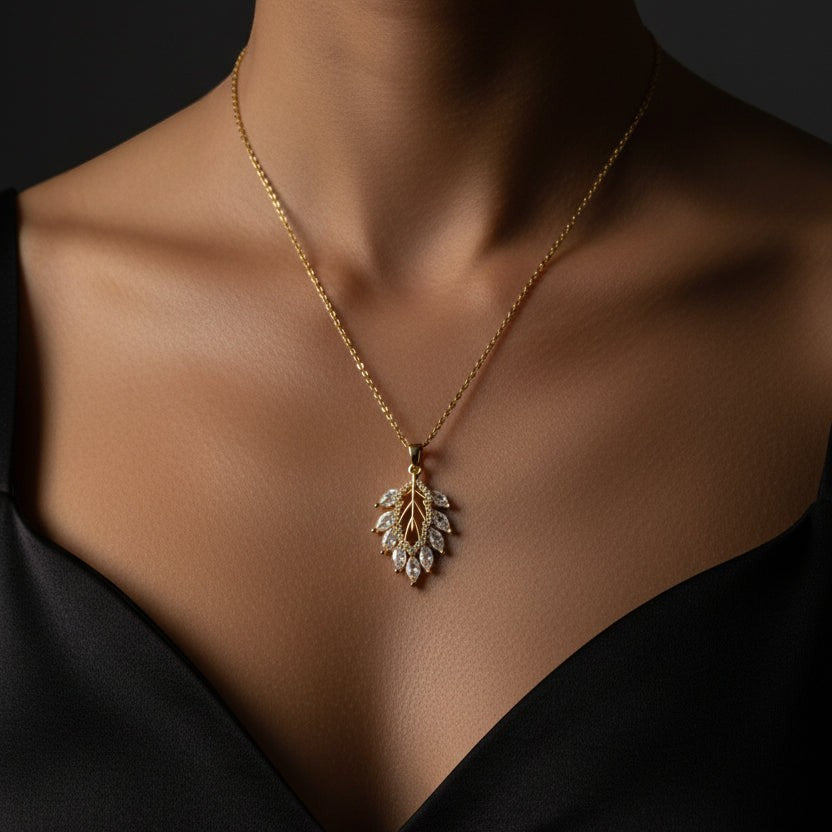 SVORA Marquise Leaf Cluster Pendant with clear CZ stones on a gold chain, 18K gold plated stainless steel.