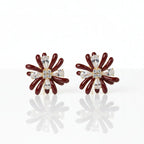 SVORA Marron Flower Crystal Stud Earrings with dark maroon enamel petals and clear baguette crystals.