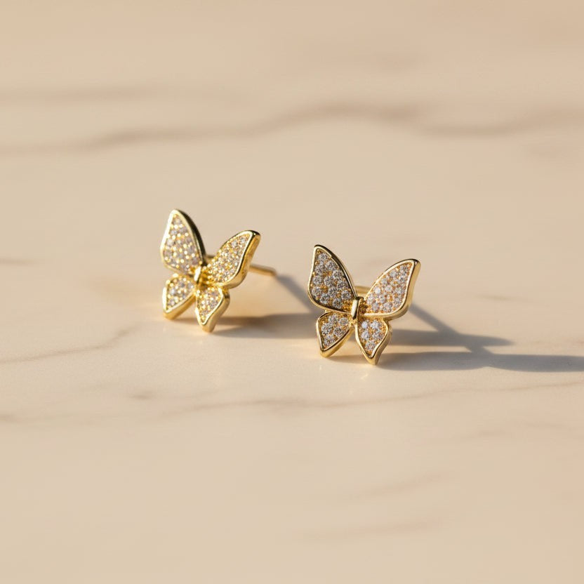 SVORA mini gold butterfly stud earrings with cubic zirconia stones, 18K gold tone plating.