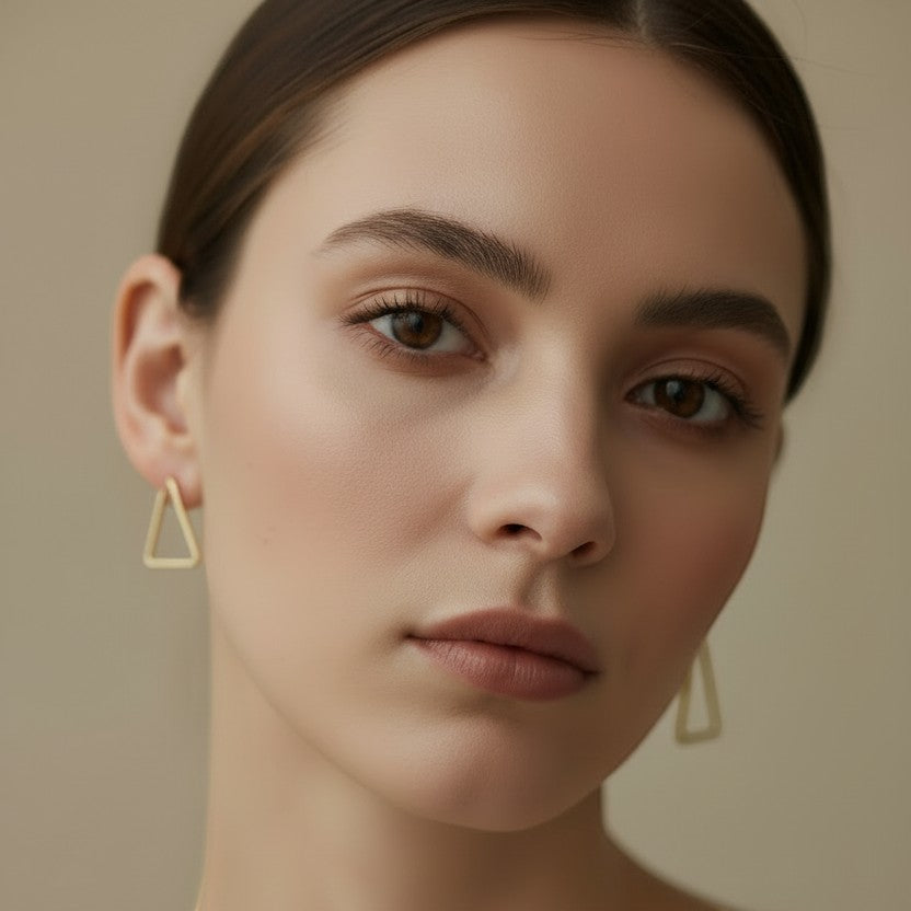 SVORA minimalist gold triangle hoop earrings made of stainless steel with 18K gold plating.