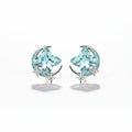 SVORA aqua cushion-cut crystal stud earrings with silver-tone crescent moon and pavé stars.