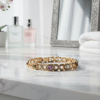 SVORA multicolor halo bracelet with oval CZs in amethyst, garnet, peridot, and white, set in 18K rose gold plated stainless steel.
