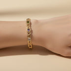 SVORA multicolor halo bracelet with oval CZs in amethyst, green, and white on rose gold plated stainless steel.