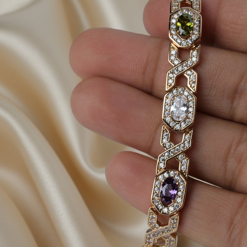 SVORA multicolor halo bracelet with oval CZs in shifting colours on rose gold plated stainless steel. Fold-over clasp.