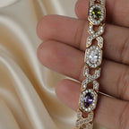 SVORA multicolor halo bracelet with oval CZs in shifting colours on rose gold plated stainless steel. Fold-over clasp.