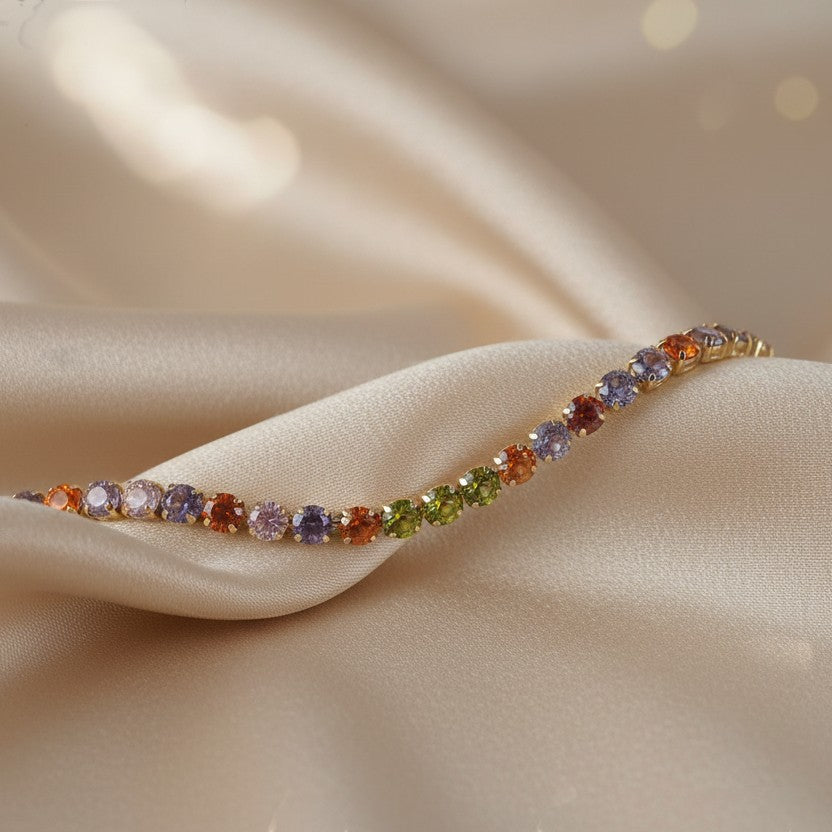 SVORA multicolor tennis bracelet with colorful crystals on a gold-tone chain, made of stainless steel.