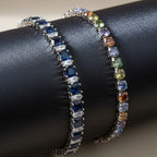 SVORA multicolor tennis bracelet with rainbow-colored crystals and gold-tone plating. Adjustable.