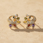 SVORA gold-tone peacock stud earrings with multicolour cubic zirconia stones in green, yellow, red, purple, and clear.