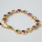 SVORA multicolour round tennis bracelet with halo cubic zirconia links in rose gold. Garnet, peridot, amethyst, peach champagne stones.