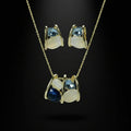 SVORA navy and smoky blue cluster necklace and earrings set with cream cabochons and gold tone metal.
