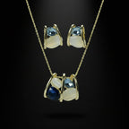 SVORA navy and smoky blue cluster necklace and earrings set with cream cabochons and gold tone metal.