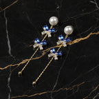 SVORA navy blue crystal bow drop earrings with pearl studs and gold chain.