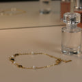 SVORA gold chain bracelet with black heart charms and pearls, 18K gold plated stainless steel.
