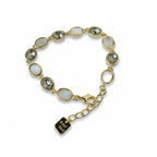 SVORA gold-tone adjustable bracelet with alternating opal grey gemstones and a good luck charm.