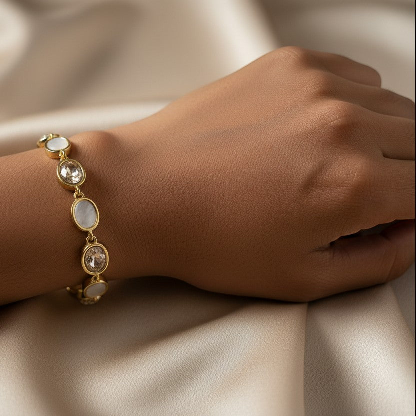SVORA gold-tone adjustable bracelet with oval pink opal and clear gemstone charms. Delicate and feminine.
