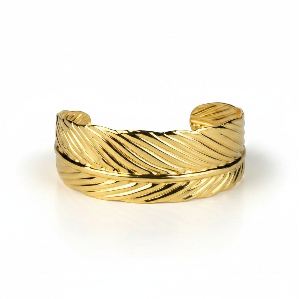 SVORA gold plated stainless steel cuff bracelet designed as a palm leaf with detailed veins. Adjustable and hypoallergenic.