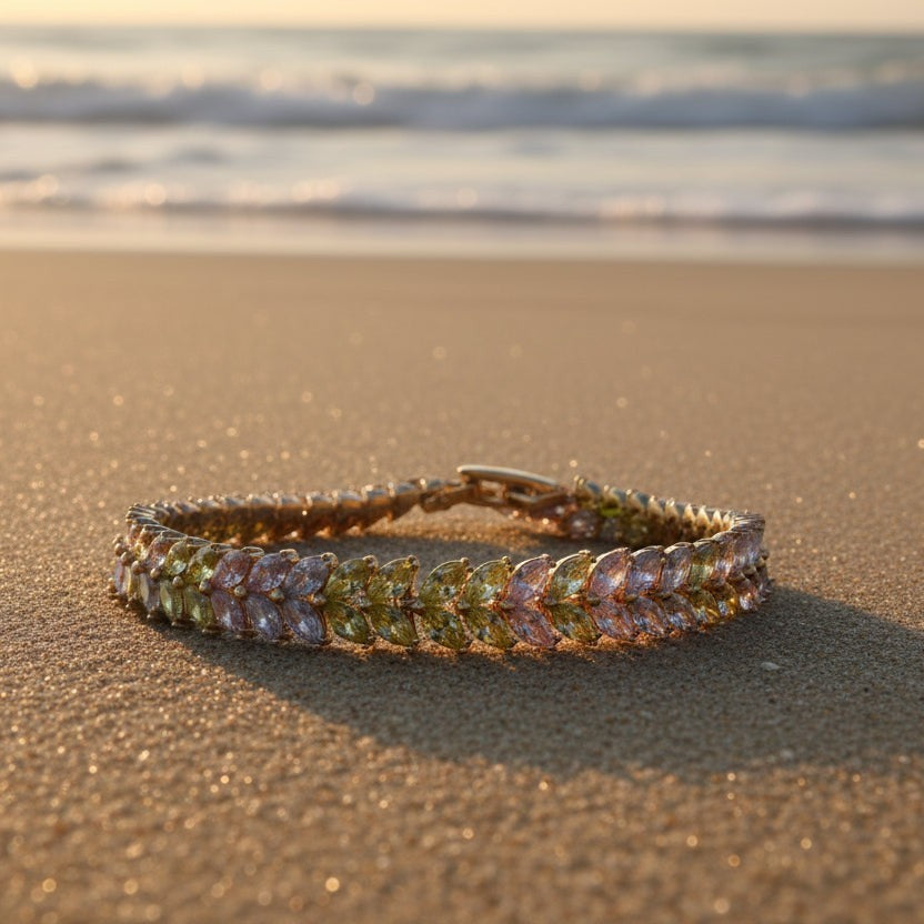 SVORA double row pastel marquise CZ tennis bracelet in pink, lavender, and mint on a beach.