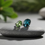 SVORA Toi et Moi Peacock Sapphire Emerald Ring with oval blue and green stones on stainless steel band.