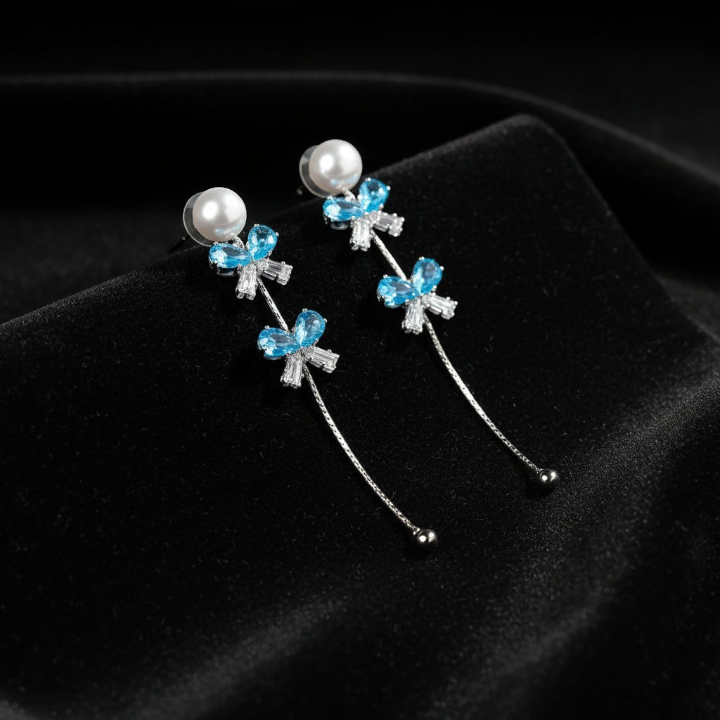 SVORA pearl stud aqua drop dangler earrings with blue crystal clusters and baguette cubic zirconia.