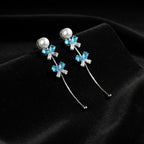 SVORA pearl stud aqua drop dangler earrings with blue crystal clusters and baguette cubic zirconia.