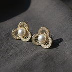 SVORA gold-tone stainless steel stud earrings with pearl center and crystal-embellished floral petals.