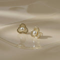 SVORA gold-tone stainless steel floral stud earrings with pearl center and crystal accents