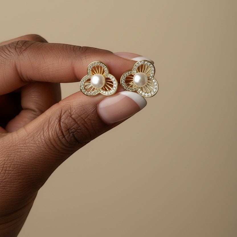 SVORA gold-tone stainless steel stud earrings with pearl center and crystal-embellished floral petals.